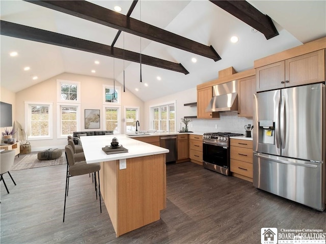 kitchen featuring stainless steel appliances, dark hardwood / wood-style floors, a breakfast bar area, and wall chimney exhaust hood