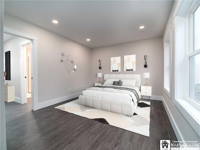 bedroom with dark hardwood / wood-style flooring