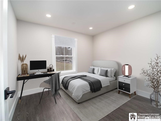 bedroom with dark hardwood / wood-style floors