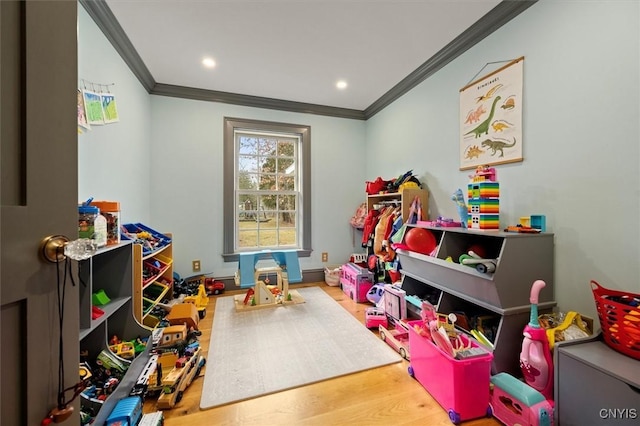 playroom featuring ornamental molding and hardwood / wood-style flooring