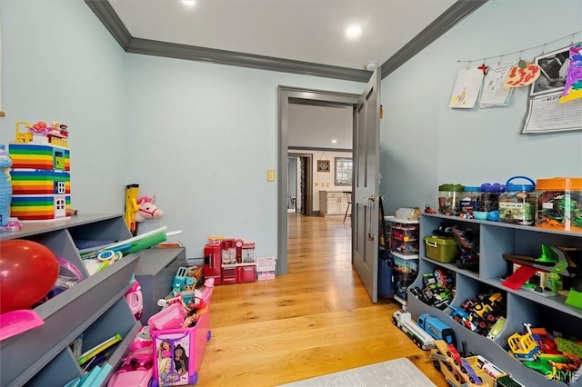 playroom featuring light wood-type flooring and ornamental molding