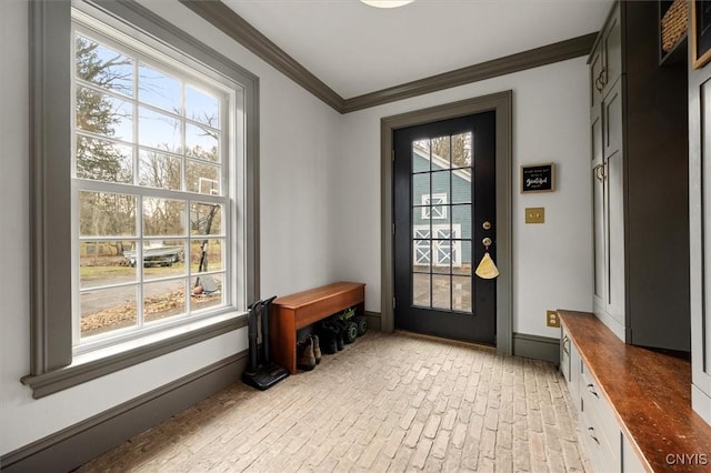 doorway with a wealth of natural light and ornamental molding