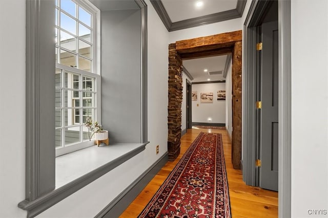 hall featuring wood-type flooring and ornamental molding