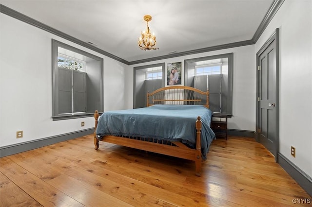 bedroom with multiple windows, wood-type flooring, and ornamental molding