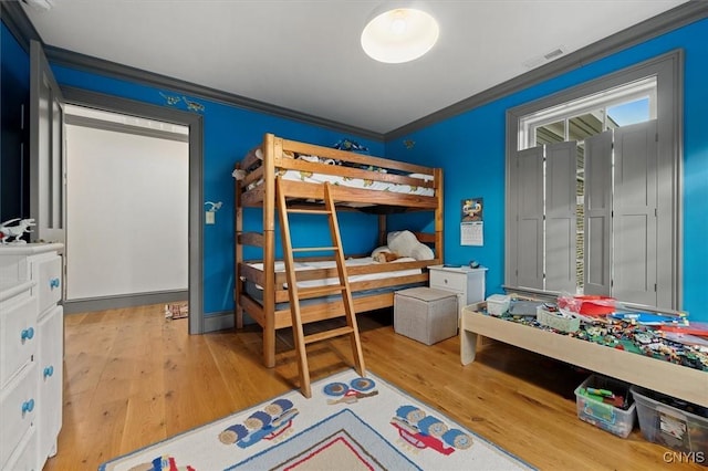 bedroom featuring light hardwood / wood-style floors and ornamental molding