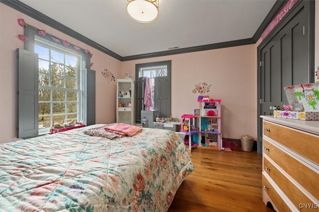 bedroom featuring crown molding and dark hardwood / wood-style floors