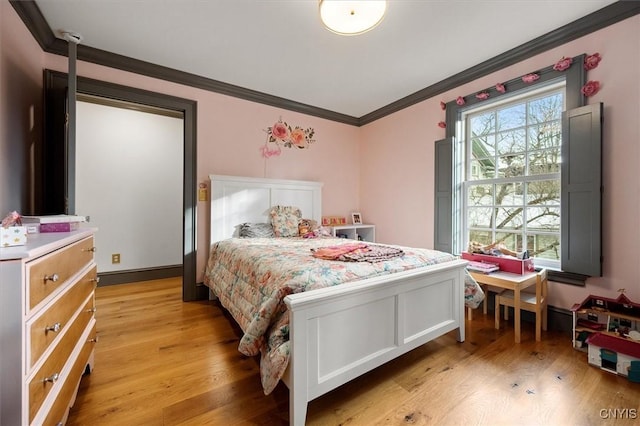 bedroom featuring light wood-type flooring and ornamental molding