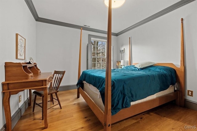 bedroom with light wood-type flooring and ornamental molding