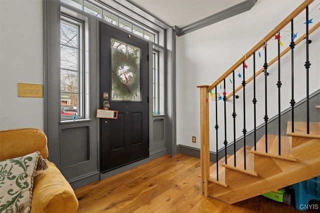 foyer with hardwood / wood-style floors and ornamental molding