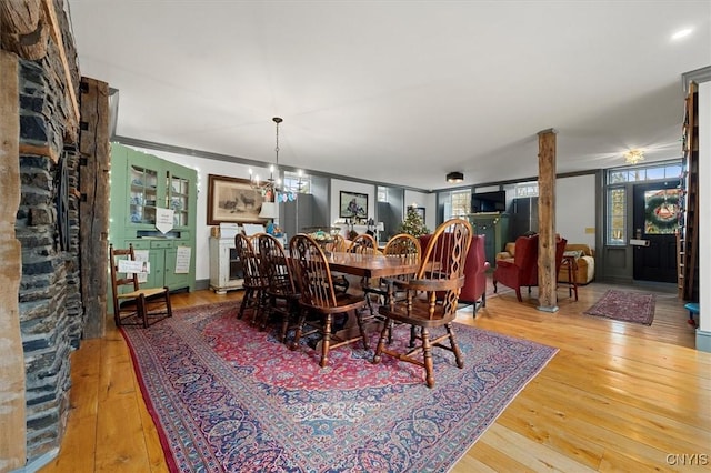 dining room with crown molding, an inviting chandelier, and hardwood / wood-style flooring