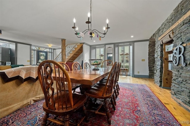 dining room featuring light hardwood / wood-style floors, crown molding, and a chandelier