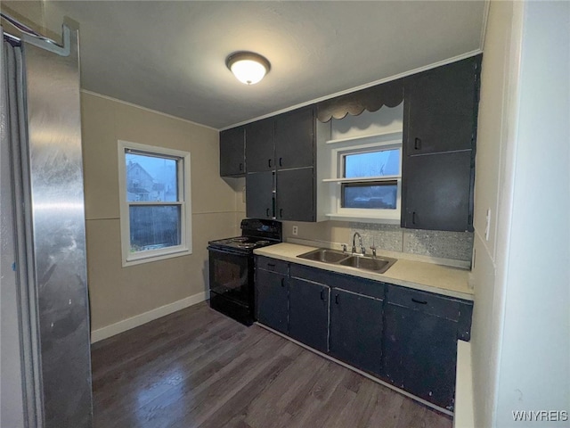 kitchen featuring black electric range, dark wood-type flooring, and sink