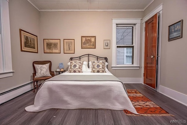 bedroom featuring baseboard heating, crown molding, and dark hardwood / wood-style flooring