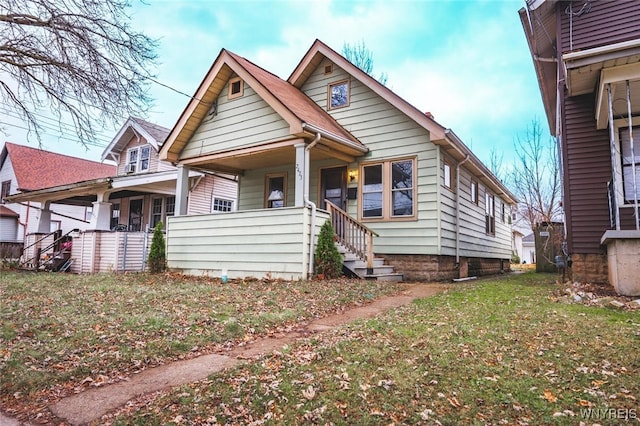 view of front of home with covered porch and a front yard