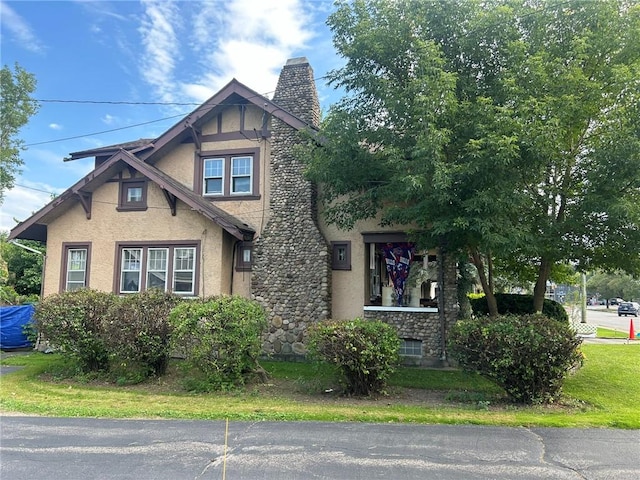 tudor-style house with a front lawn