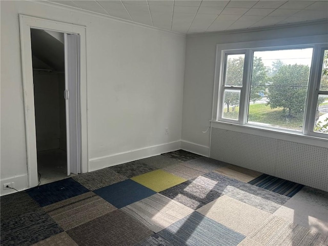 spare room featuring crown molding