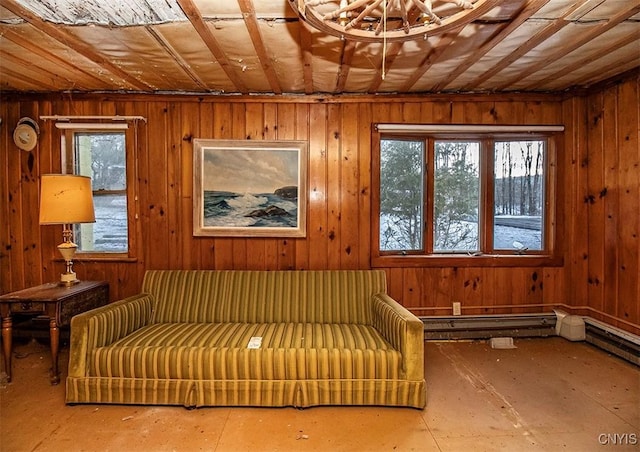 sitting room featuring wooden walls and a wealth of natural light