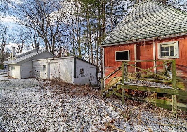 view of snow covered exterior featuring an outdoor structure