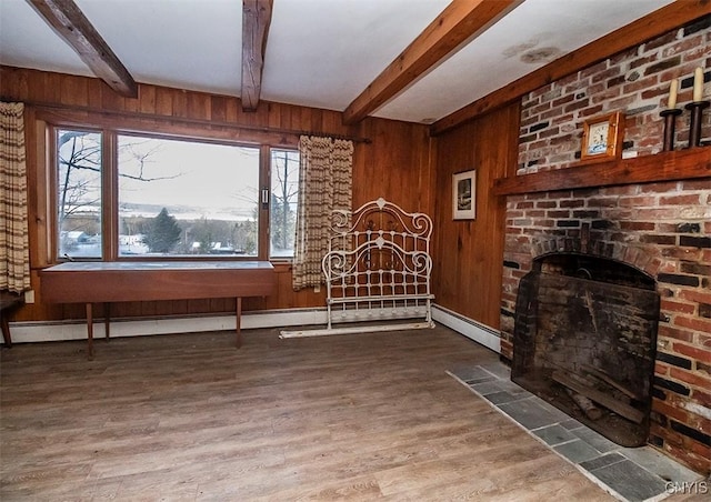 living room featuring wooden walls, hardwood / wood-style floors, and a brick fireplace