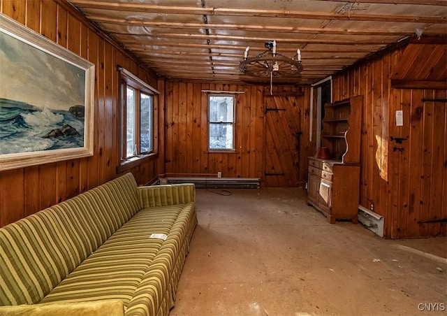 interior space featuring baseboard heating and wood walls