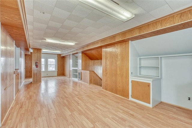 bonus room featuring wood walls and light hardwood / wood-style floors