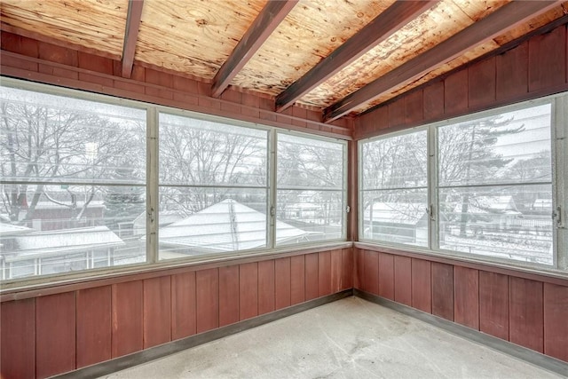 unfurnished sunroom featuring vaulted ceiling with beams