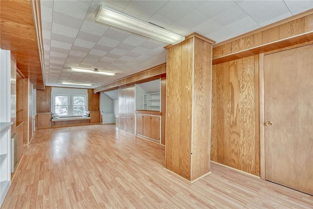 interior space with wooden walls and light wood-type flooring