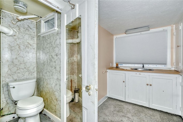 bathroom featuring sink, a baseboard radiator, a textured ceiling, and toilet