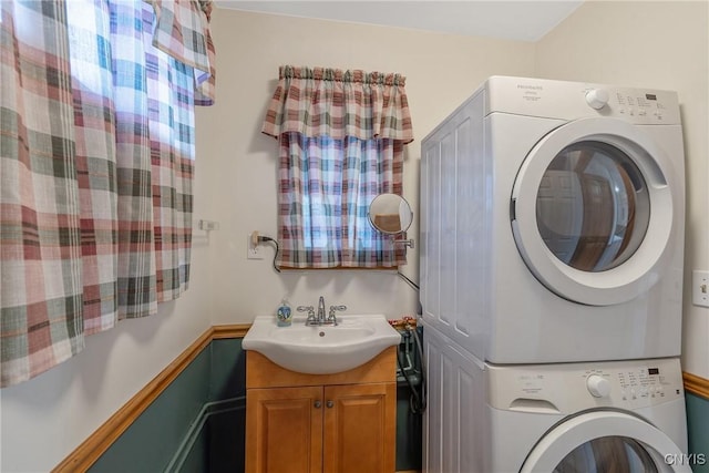 laundry room featuring sink and stacked washer and dryer