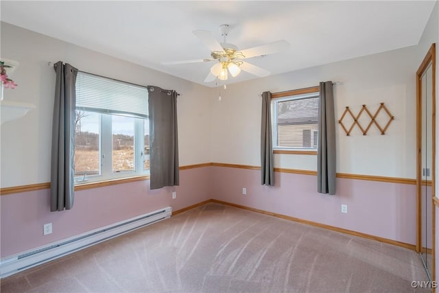 unfurnished room with ceiling fan, baseboard heating, and carpet