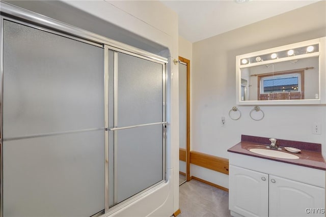 bathroom with combined bath / shower with glass door and vanity