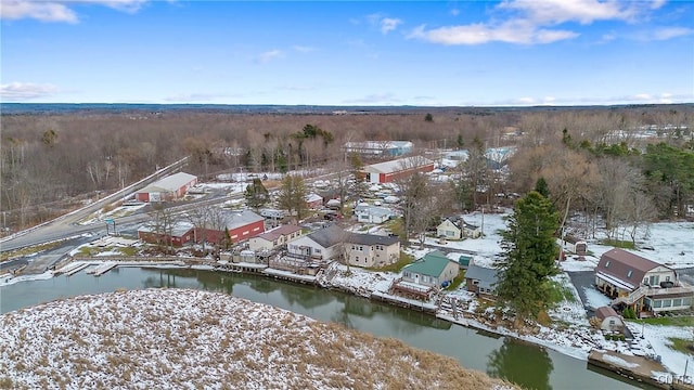 snowy aerial view featuring a water view