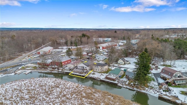 snowy aerial view with a water view