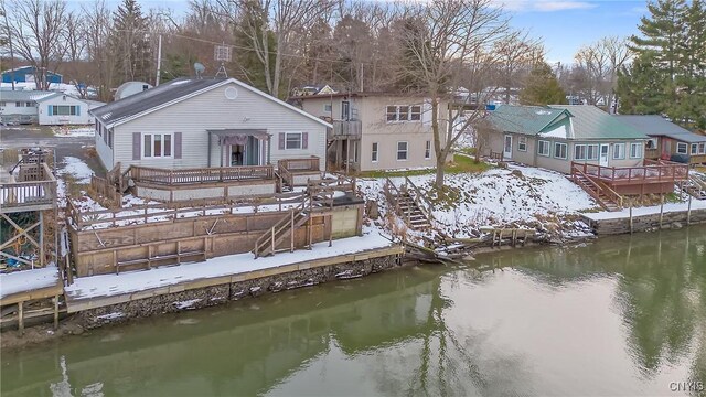 rear view of house with a deck with water view