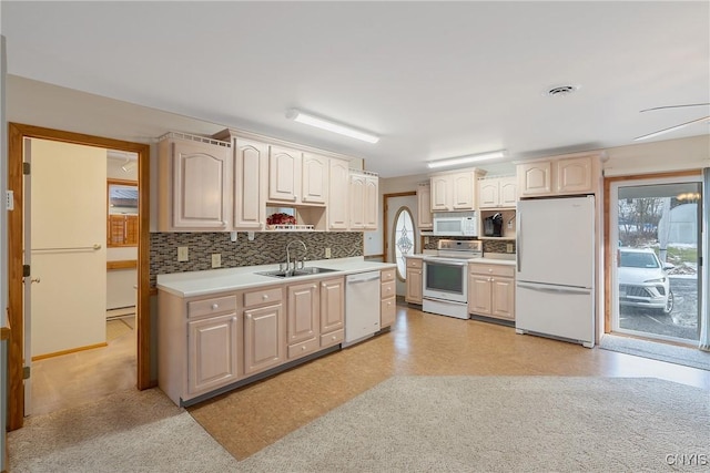 kitchen with sink, backsplash, and white appliances