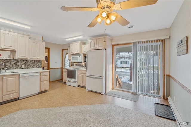 kitchen with sink, backsplash, white appliances, and ceiling fan