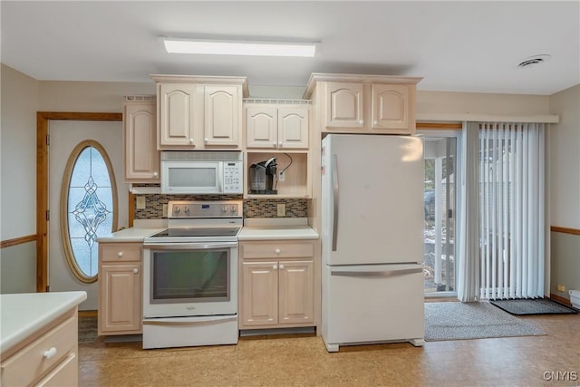 kitchen featuring white appliances and tasteful backsplash