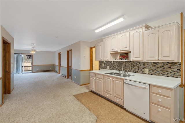 kitchen with sink, dishwasher, ceiling fan, and decorative backsplash