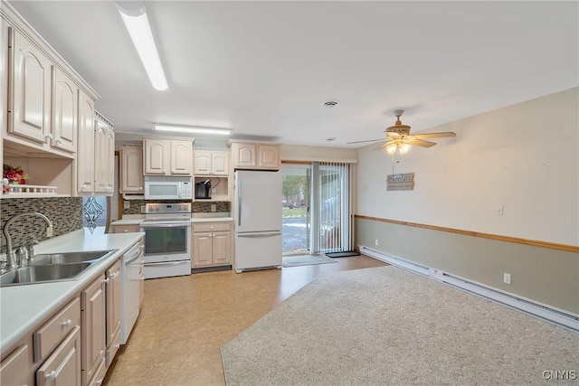 kitchen featuring a baseboard heating unit, ceiling fan, sink, white appliances, and decorative backsplash