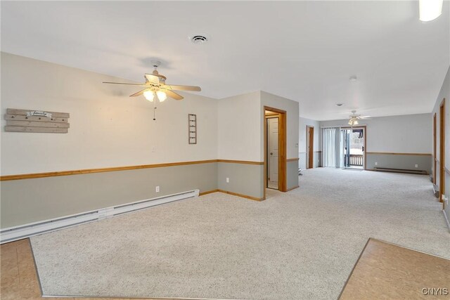 empty room with a baseboard radiator, light colored carpet, and ceiling fan