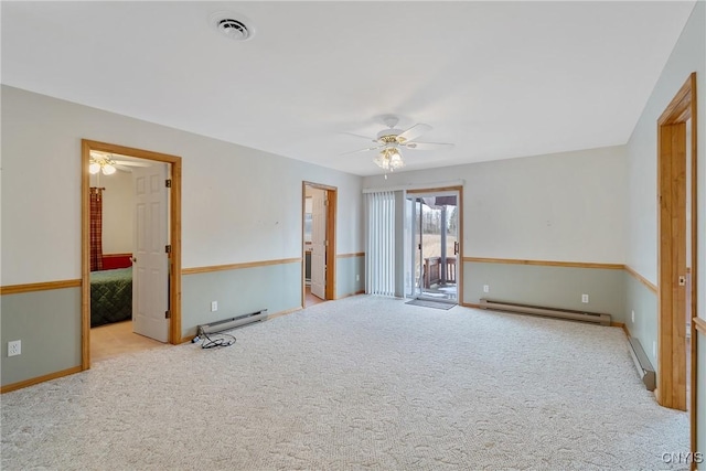 empty room featuring baseboard heating, light colored carpet, and ceiling fan