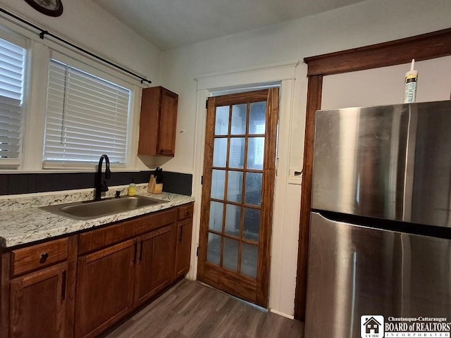 kitchen featuring stainless steel fridge, sink, and dark wood-type flooring