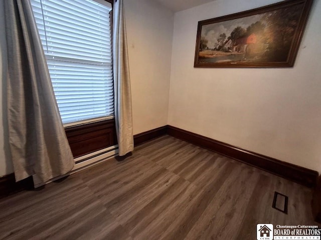 unfurnished room with dark wood-type flooring