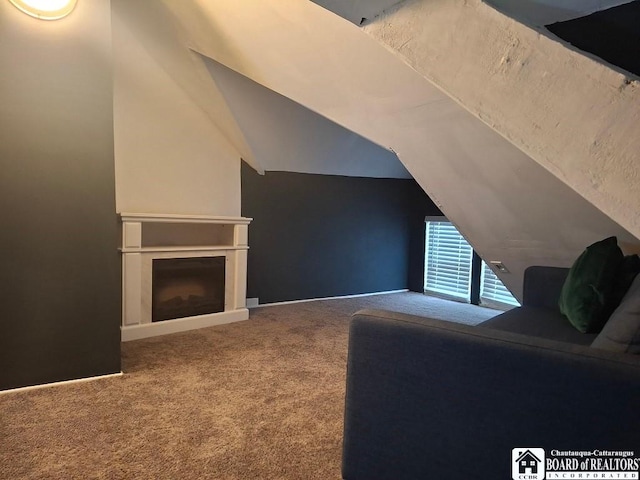 carpeted living room with vaulted ceiling