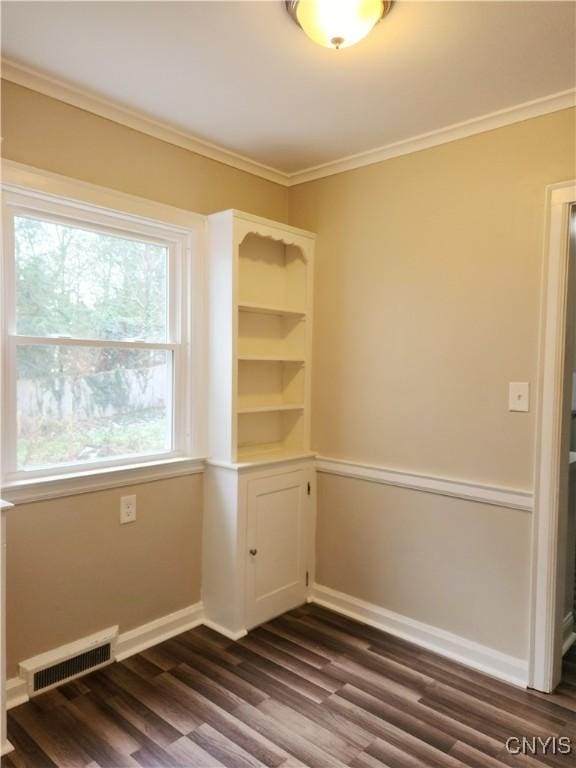 spare room with crown molding and dark hardwood / wood-style floors