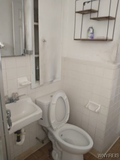 bathroom featuring toilet, tile walls, sink, and hardwood / wood-style flooring