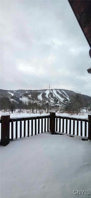 snow covered patio featuring a mountain view