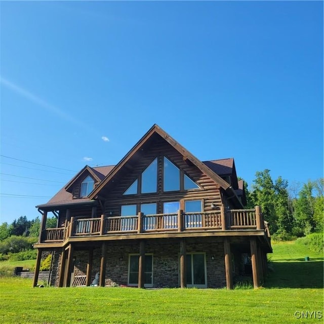 rear view of house with a lawn and a wooden deck