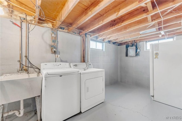 laundry area with independent washer and dryer and sink