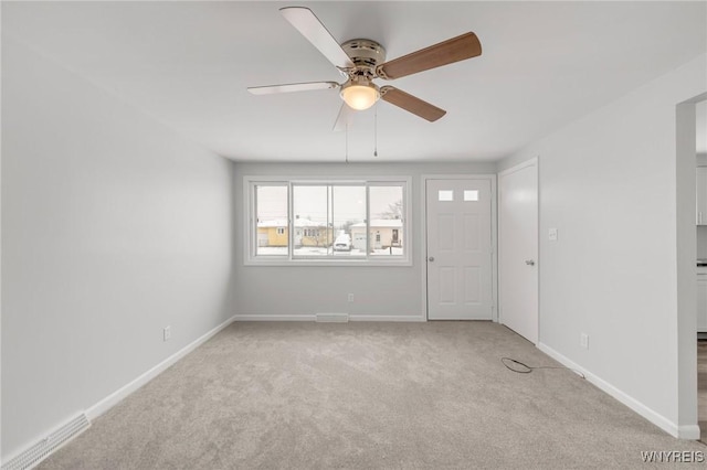 empty room featuring light carpet and ceiling fan